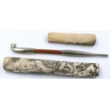 A Japanese Meiji period white metal and bamboo opium pipe, held within a carved and polished bone