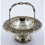A Japanese white metal sweetmeats basket with pierced chrysanthemum decoration to the rim and