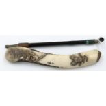 A Japanese Meiji period carved and polished bone pipe case, signed, holding a white