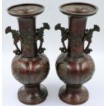 A pair of Japanese Meiji period bronze vases, the tubular necks with applied koi-form handles,