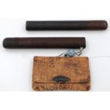 A Japanese Meiji period leather tobacco pouch mounted with a bronze fan, with a fine carved two-