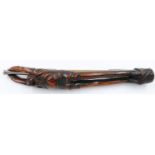A Japanese Meiji period figural carved and lacquered bamboo pipe case with a white metal mounted