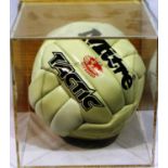 White Mitre football signed by Wilf McGuinness, Rodney Marsh and George Best, in display case. Not