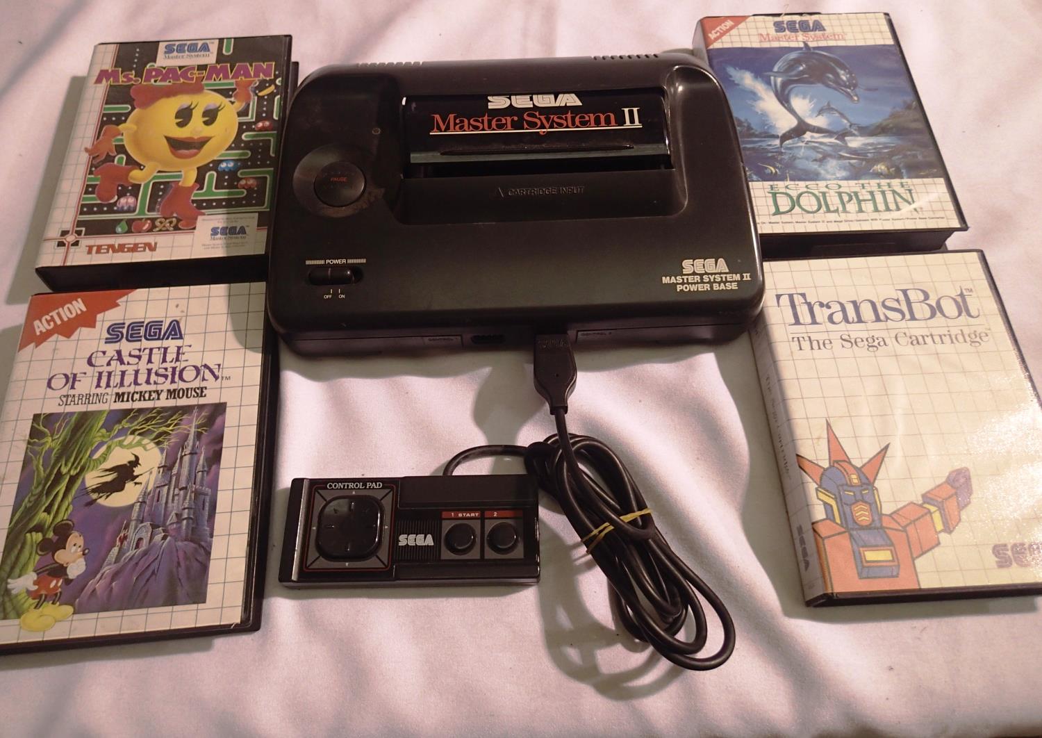 Sega Master System II base unit with one controller and four games. Three complete with paperwork,