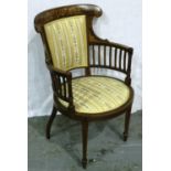 An Edwardian inlaid walnut elbow chair with circular upholstered seat and tapering supports. Not