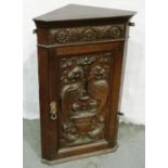 Heavily carved oak single door wall hanging cupboard, with Griffins and flora, 46 x 71 cm H. Not