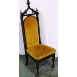 A Victorian mahogany hall chair, upholstered and carved in the Gothic manner. Not available for in-