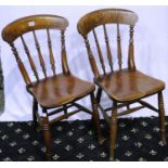 A pair of 19th century country elm kitchen chairs with turned spindle backs. Not available for in-