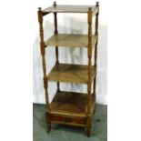 An early 20th century walnut etagere, two shelves and with single drawer, 42 x 39 x 121 cm H, splits