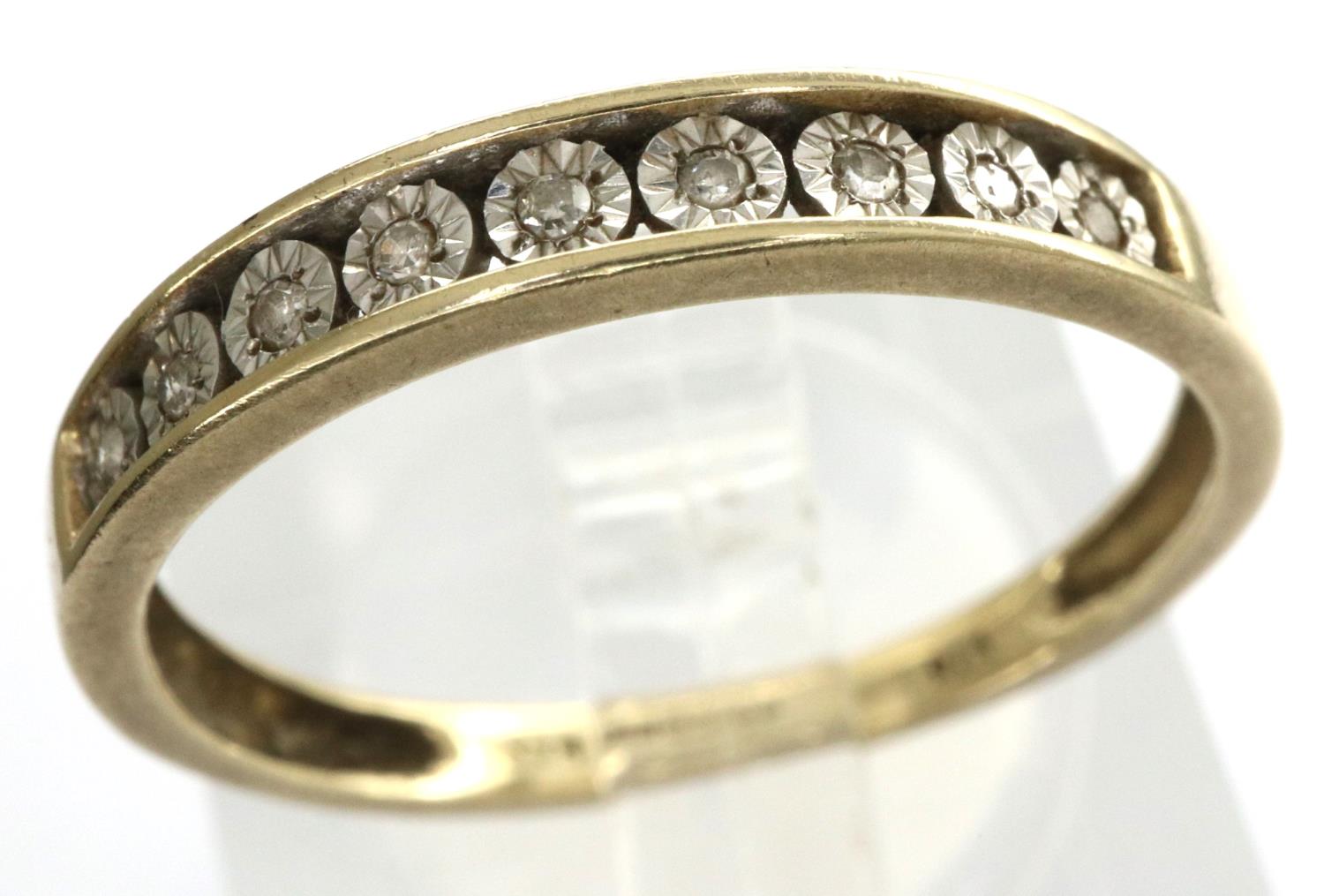 9ct gold band set with nine graduating diamonds, size N/O, 1.3g. P&P Group 1 (£14+VAT for the