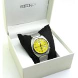 Seiko: automatic water resistant 100M wristwatch, with yellow dial and day and date aperture, boxed,