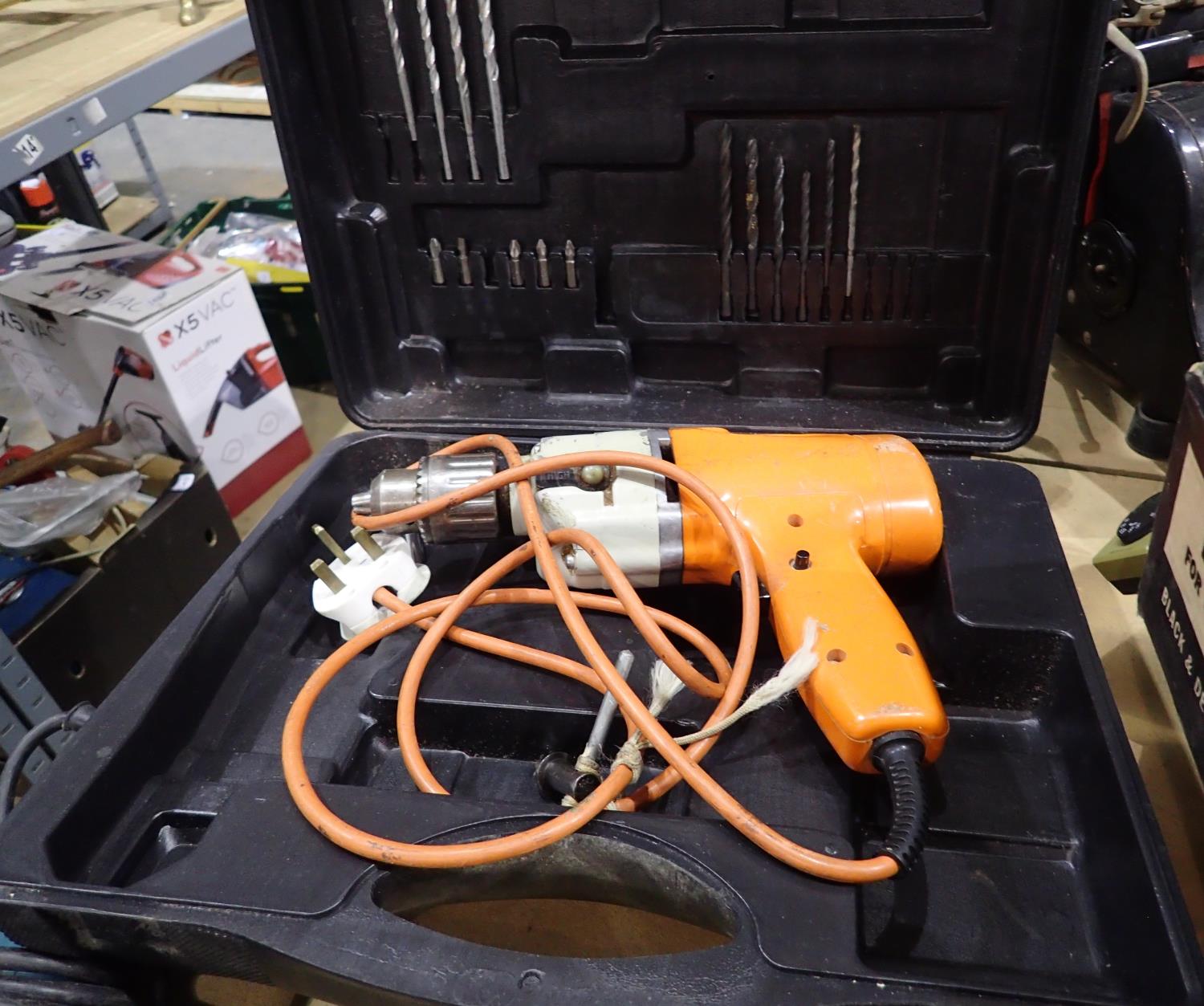 Power base corded drill including hard case with drill bits. All electrical items in this lot have
