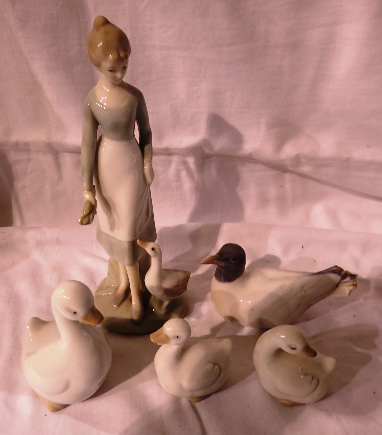 Three Bristolian Geese, Royal Copenhagen gull (tail damaged) and a Lladro type girl figurine,
