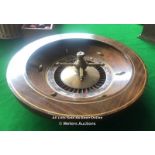 ANTIQUE ROULETTE WHEEL IN WALNUT VENEERED CIRCULAR CASING, WITH HEAVY CAST BRASS REMOVABLE CENTRE