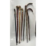 SEVEN WALKING CANES INCLUDING VICTORIAN BRASS BOUND EXAMPLE, VULTURE HEADED EXAMPLE, ETC