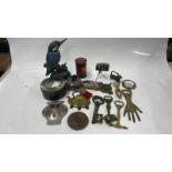 QUANTITY OF COLLECTIBLES INCLUDING BUCKLES, CAR BADGES, WHISKY FLASK MODELLED AS A CURLING STONE,