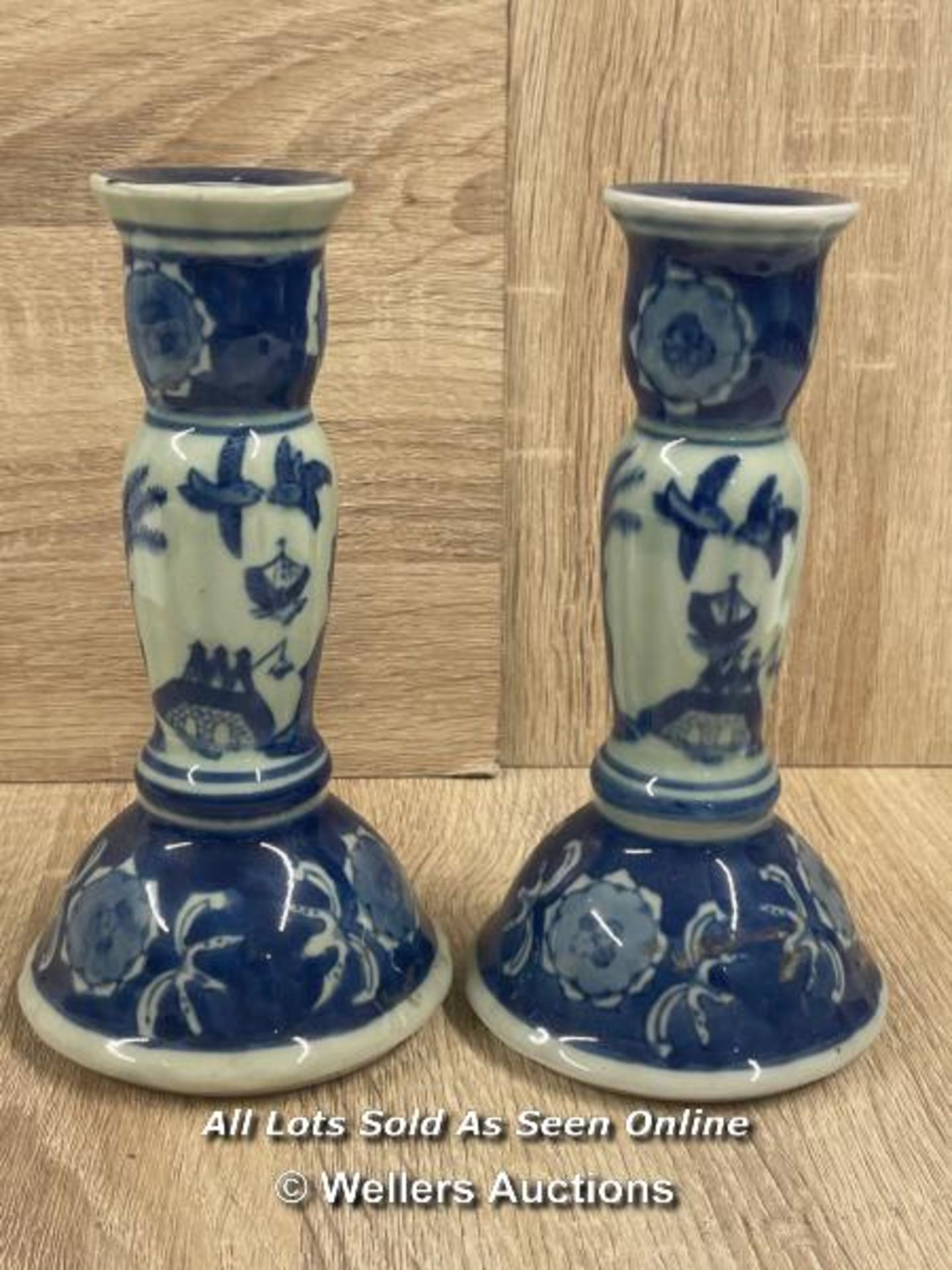 A PAIR OF CHINESE BLUE & WHITE CANDLE HOLDERS DECORATED WITH SCENERY.17.6CM HIGH