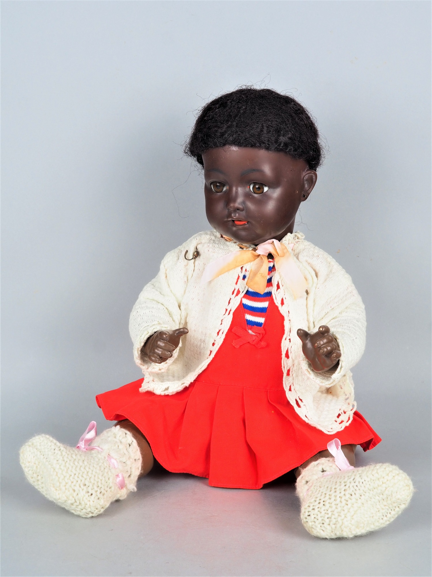 Baby doll, dark skinned, around 1920