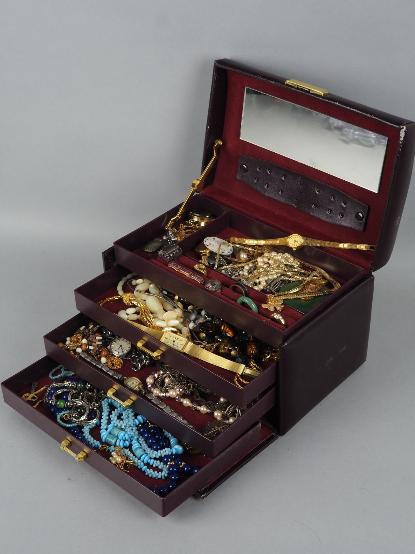 Convolute costume jewelry in jewelry case.