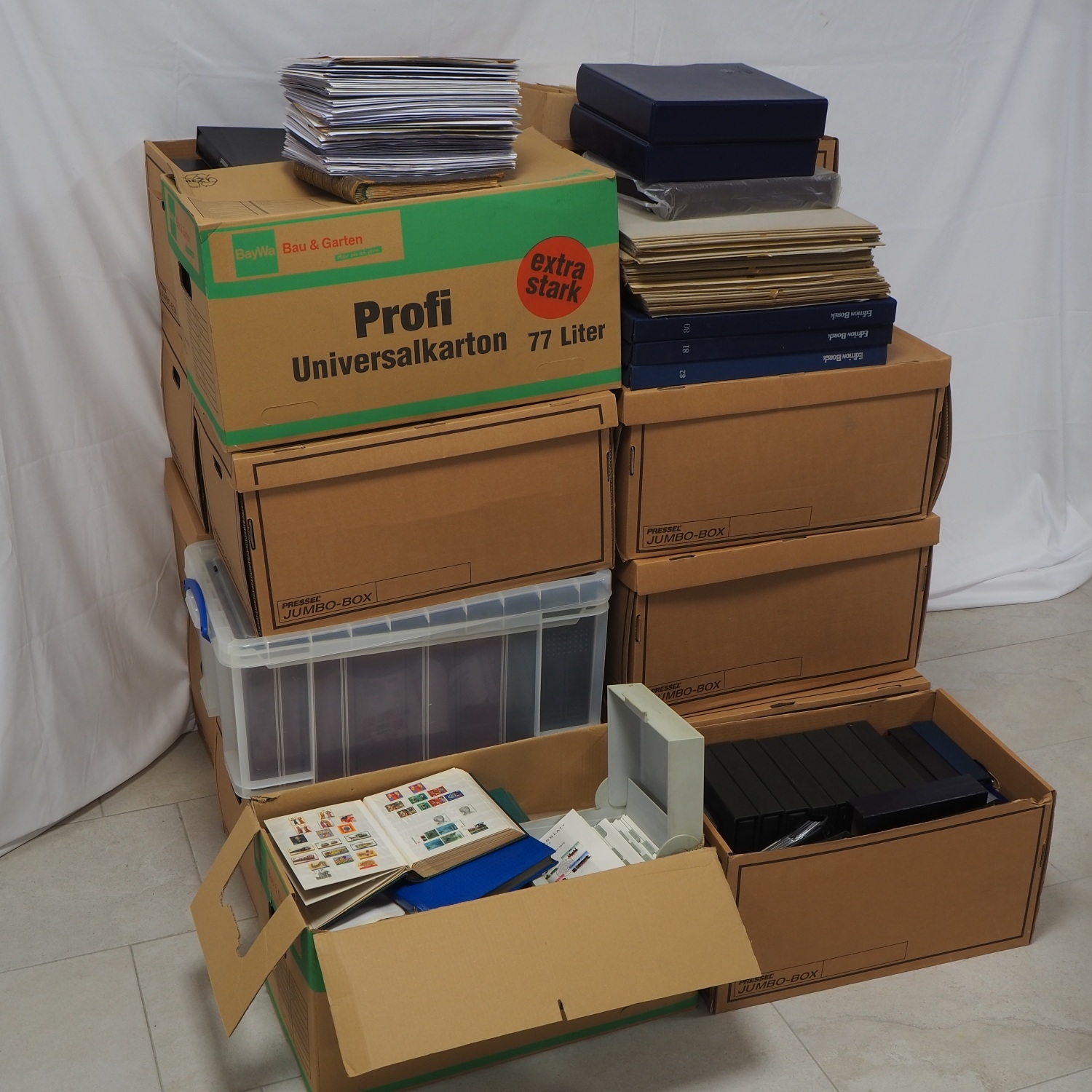 Huge assortment of stamps, plus numismatic sheets with commemorative coins, 18 full moving boxes
