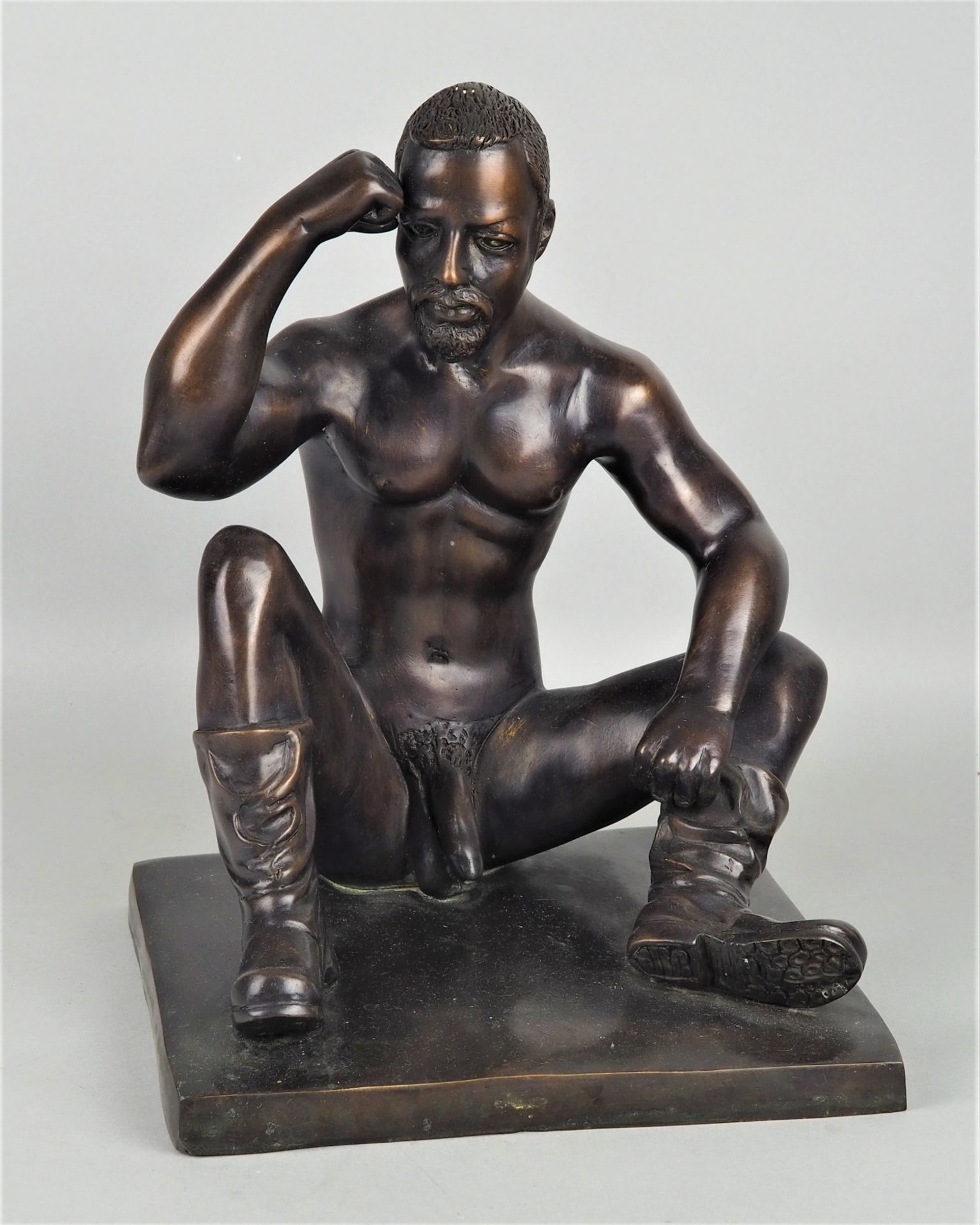 Sitting male nude with leather boots, bronze figure