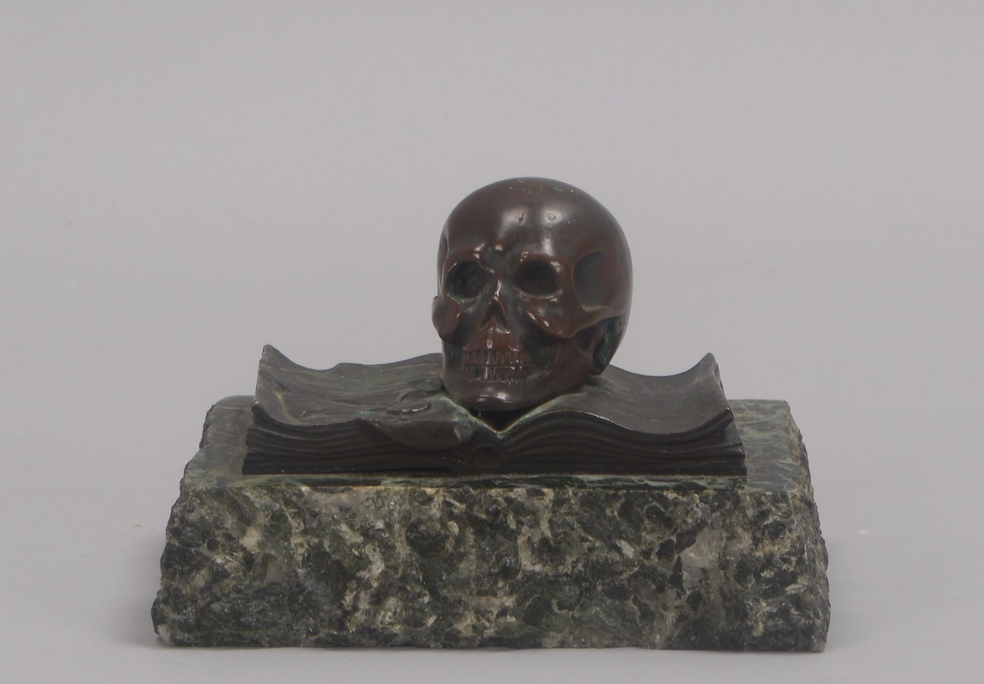 Tischskulptur, Bronze, 'Totenkopf' (mit Schreibfeder auf aufgeschlagenem Buch dargestellt), auf Marm