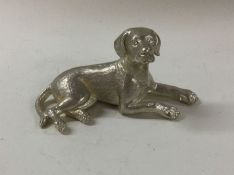 A silver model of dog in seated position. Approx.