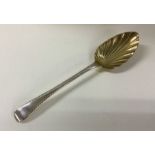A George III silver feather edged serving spoon. L