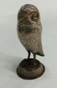 A heavy Continental silver figure of an owl in sta