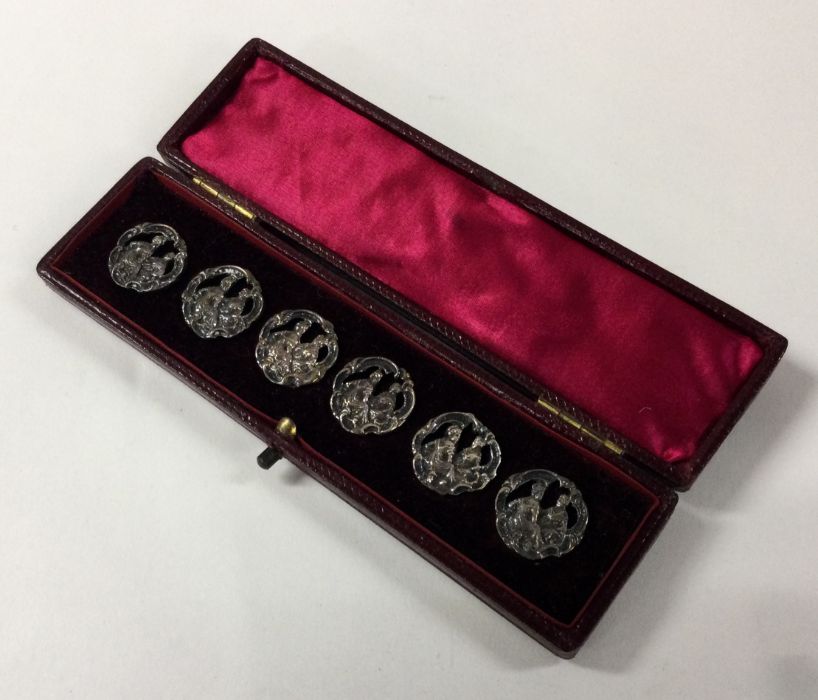 A box containing six stylish silver buttons. Birmi