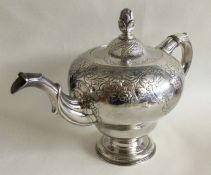 EDINBURGH: A heavy cast silver teapot decorated wi