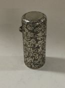 A chased Victorian silver scent bottle. London 1890