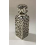 A chased silver scent bottle with hinged lid. Birm