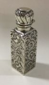 A chased silver scent bottle with hinged lid. Birm