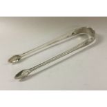 A pair of bright cut George III silver ice tongs.