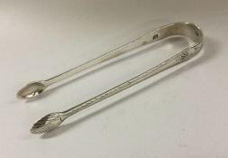 A pair of bright cut George III silver ice tongs.