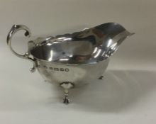 An Edwardian silver sauce boat with card cut rim.