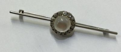 A small white gold moonstone and diamond cluster m