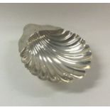 An Edwardian silver scallop shaped butter shell on