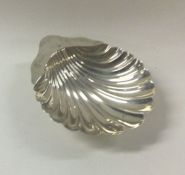 An Edwardian silver scallop shaped butter shell on