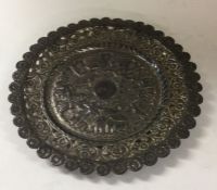 A chased Indian silver pin dish. Approx. 58 grams.
