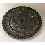 A chased Indian silver pin dish. Approx. 58 grams.