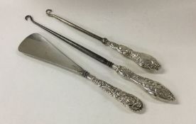 A collection of silver handled button hooks and a