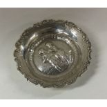 A heavy large circular silver sweet dish in relief