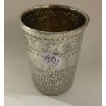 A chased silver thimble beaker. Birmingham 1959. B