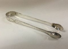 A pair of bright cut George III silver ice tongs.