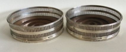 A good pair of Georgian silver wine coasters with