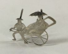 A pierced Chinese silver menu holder in the form o