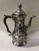 A large George III chased silver coffee pot. Londo