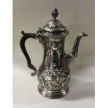 A large George III chased silver coffee pot. Londo